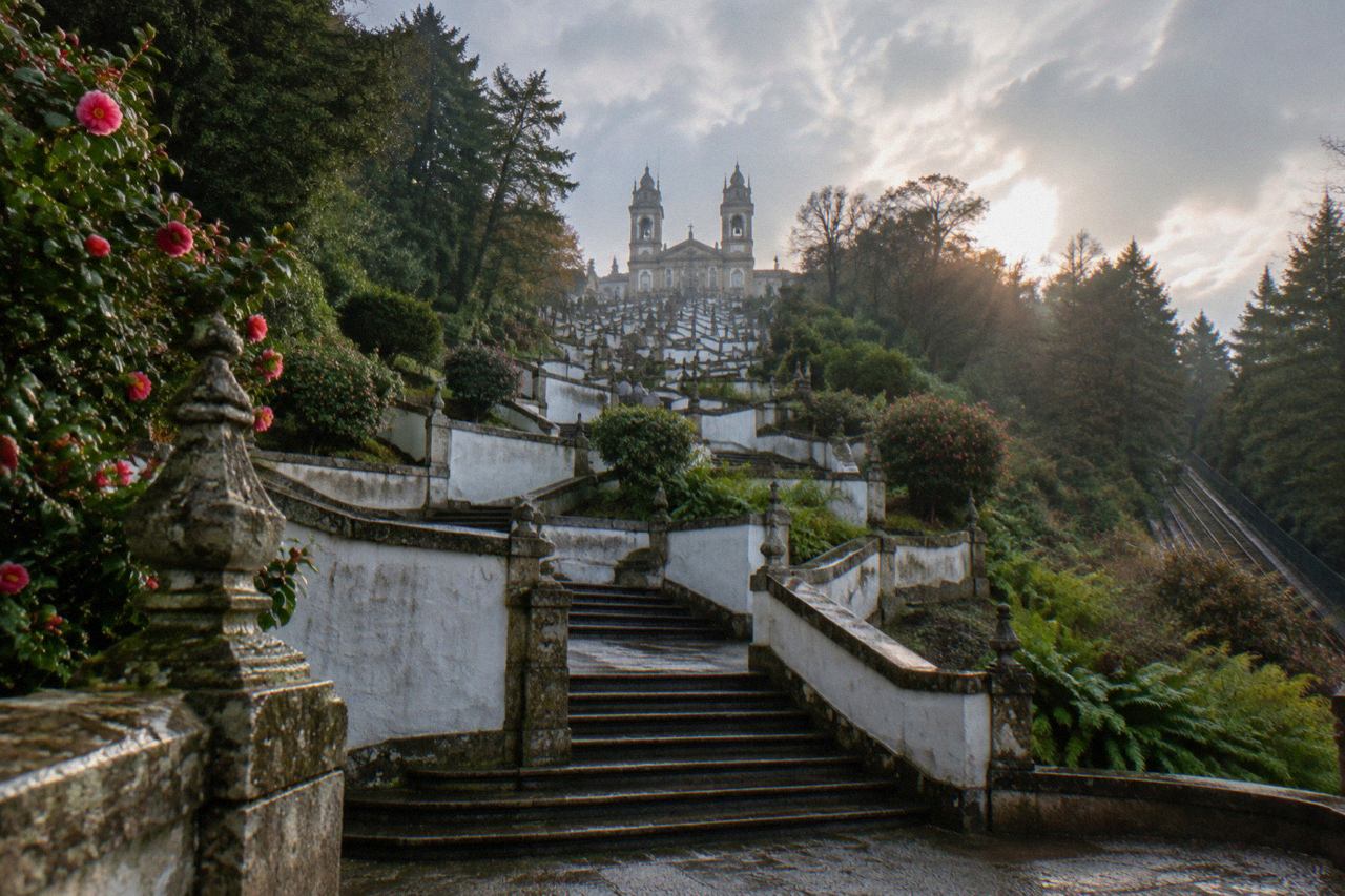 The monumental baroque stairway of Bom Jesus do Monte zigzagging up the wooded hillside above Braga
