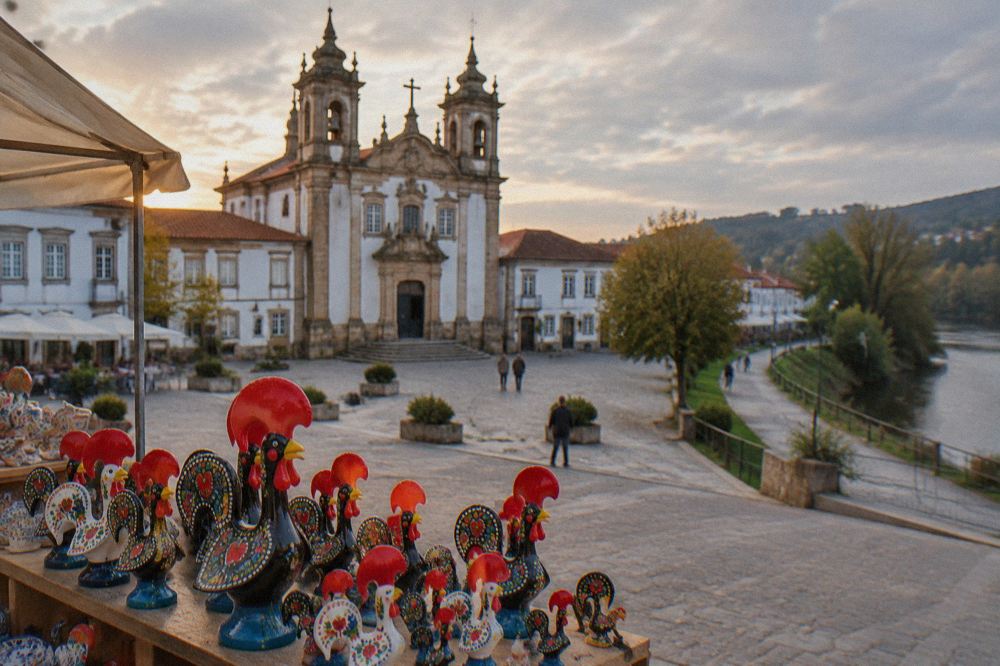 Painted ceramic rooster souvenirs displayed on a market stall in Barcelos