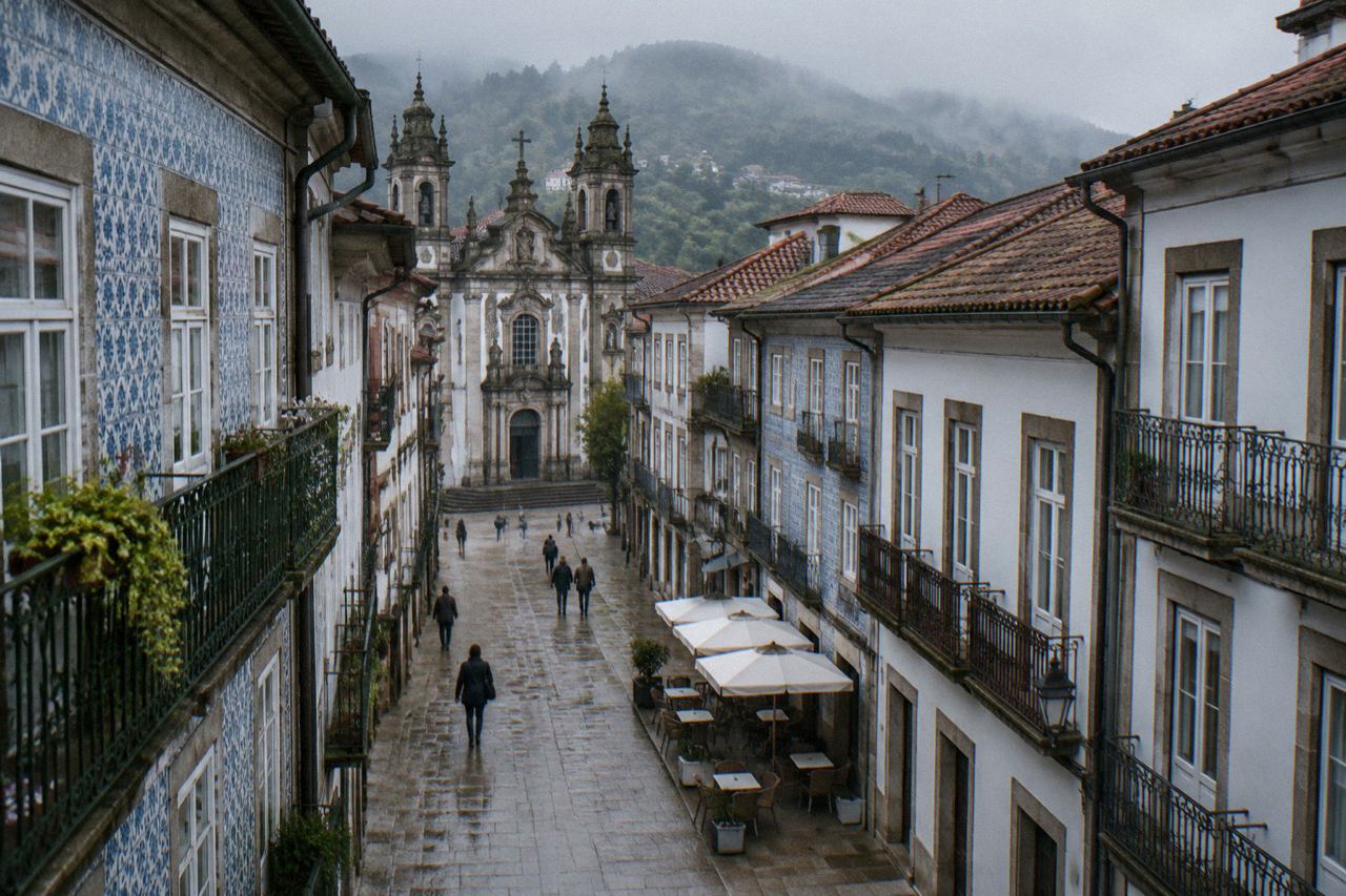 A quiet pedestrian street in Braga's historic centre with café tables and baroque building facades