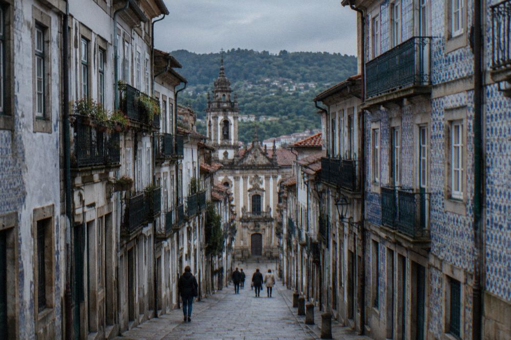 Porto's riverside quarter above the Douro with the iron bridge and port wine lodges on the far bank