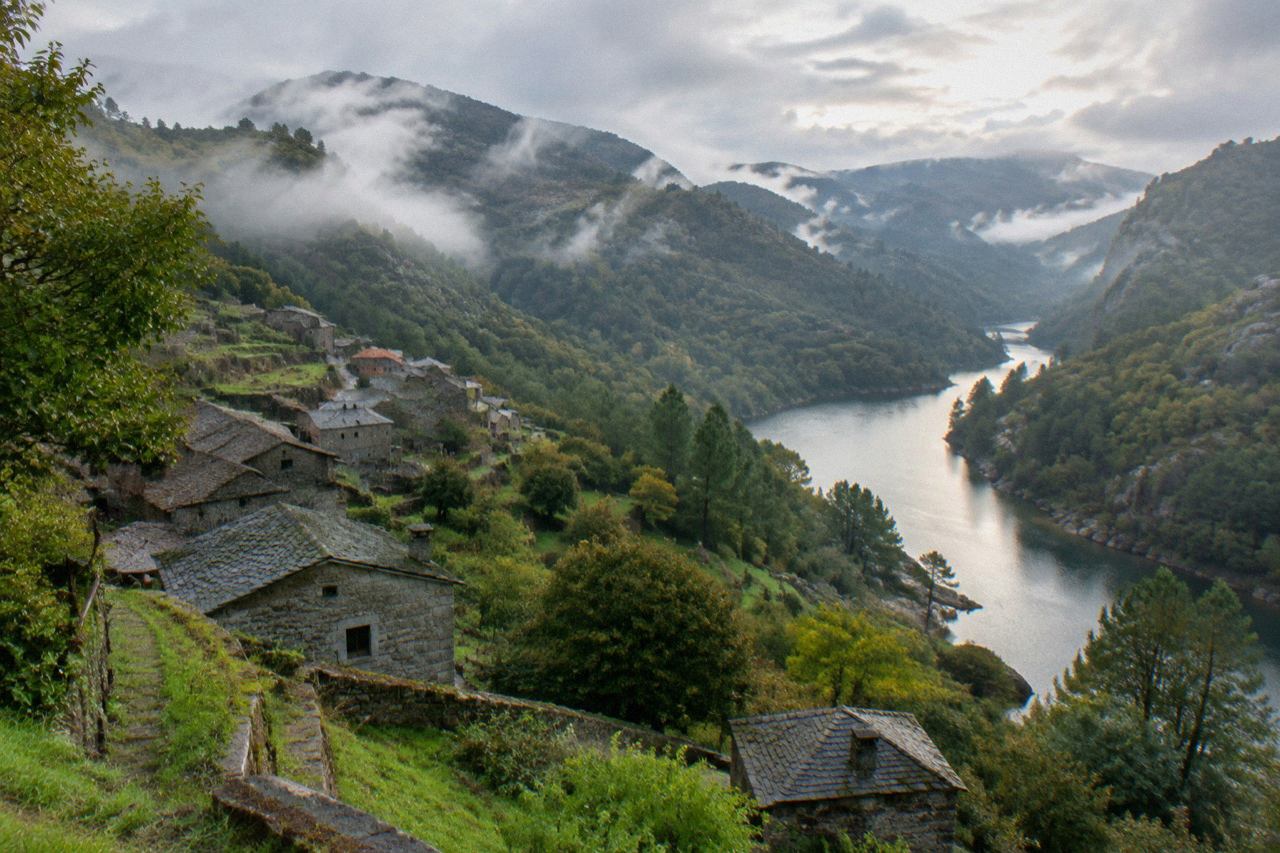 Wooded mountain slopes and a river in Peneda-Gerês National Park on a clear day
