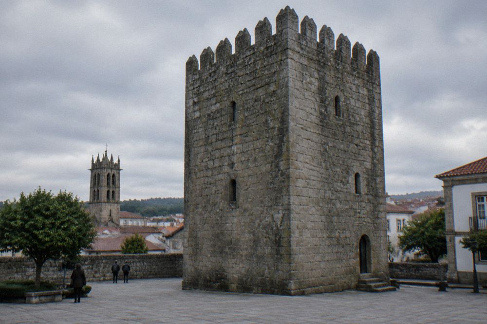 Two medieval towers rising above a walled old town in northern Portugal