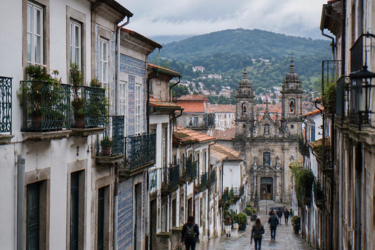 View over Braga's rooftops and church towers with hills rising behind the city