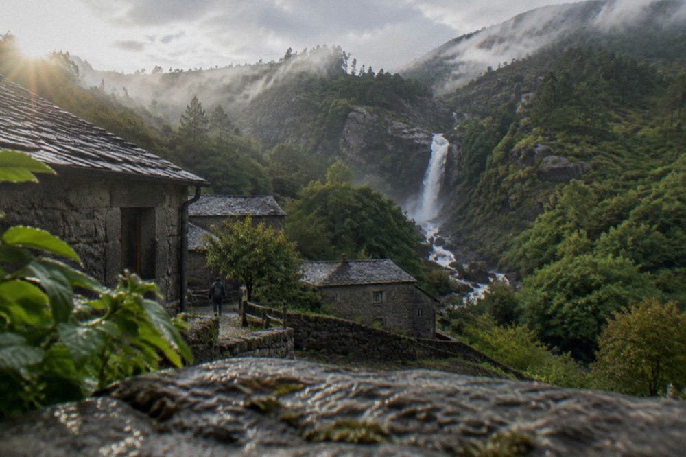 A waterfall dropping through a green ravine in the Gerês mountains