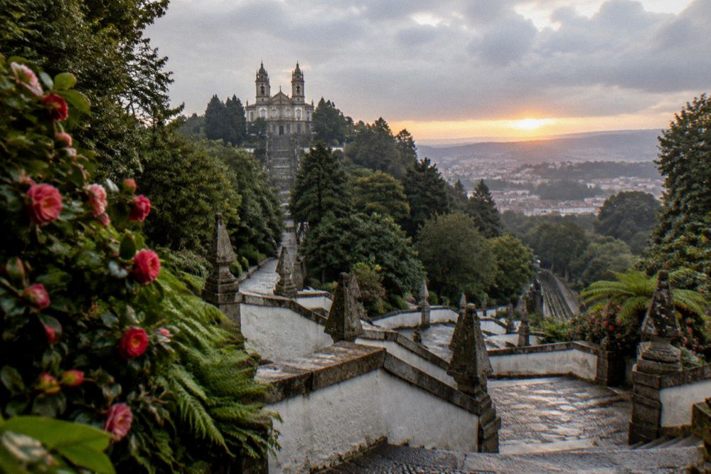 The Bom Jesus gardens and basilica silhouette at sunset above the city