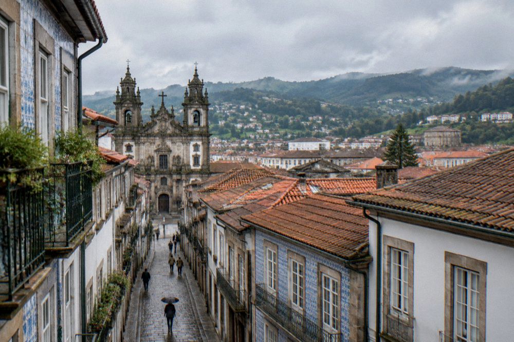 Aerial-style view over Braga rooftops toward the eastern districts and hills