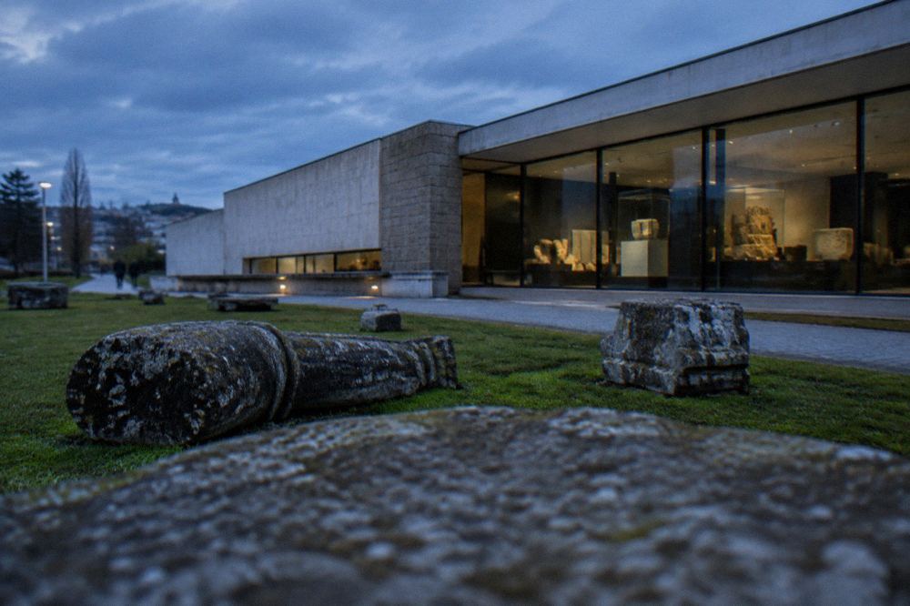 Stone artefacts and display cases inside the archaeology museum in Braga