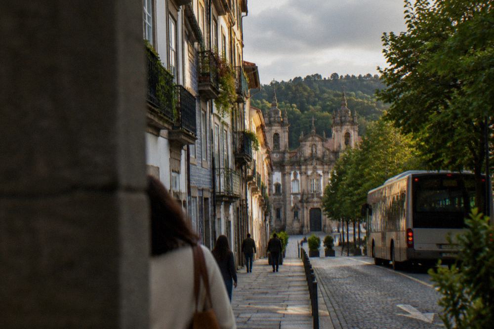 A city bus on a tree-lined avenue at the edge of Braga's old town