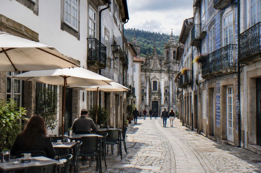 A small neighbourhood café with tables on the pavement in a Braga side street