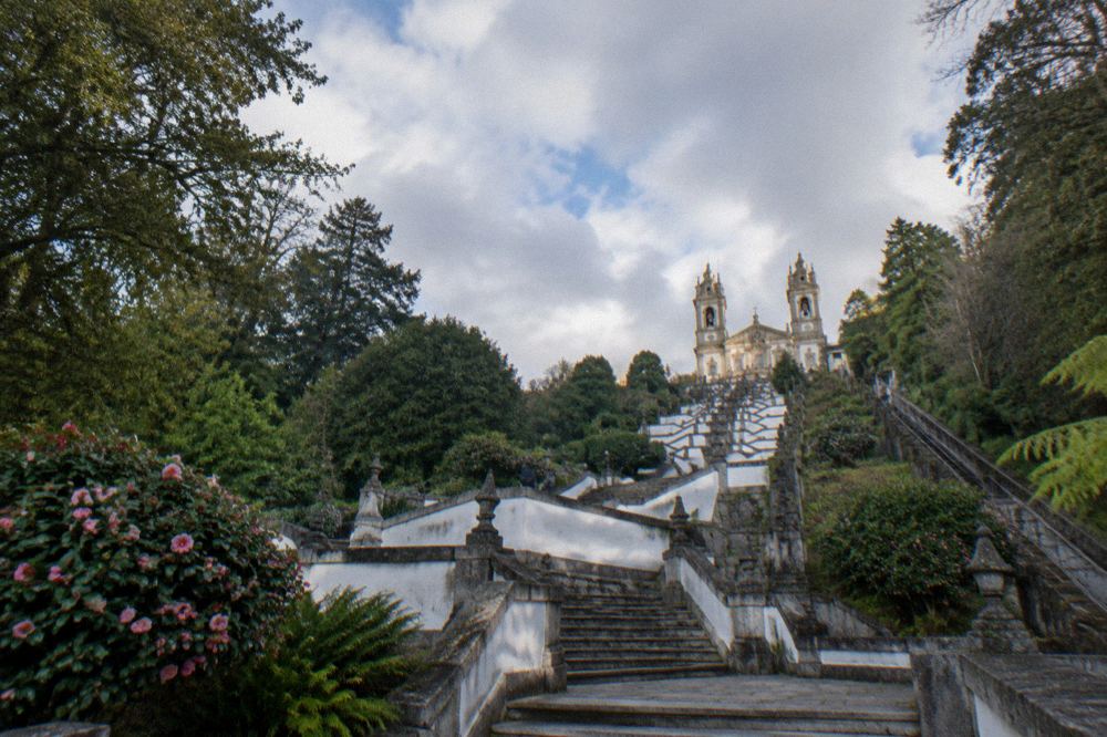The baroque stairway of Bom Jesus do Monte climbing through green woodland above Braga