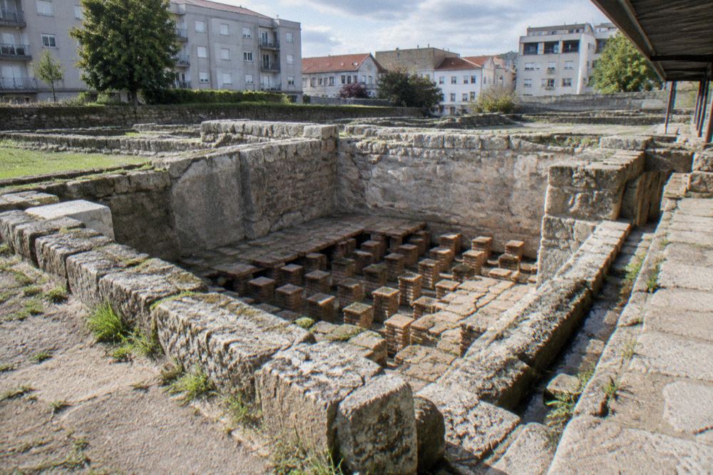 A stone chamber of the Roman baths in Braga with hypocaust channels visible under the floor level