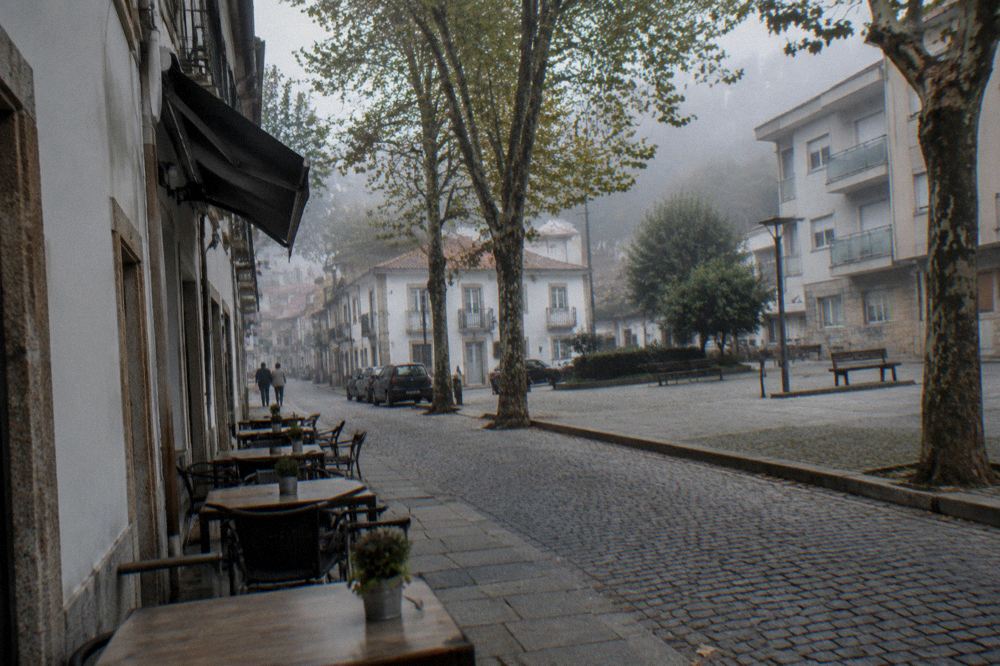 A small neighbourhood cafe with tables on a quiet street in the Maximinos quarter of Braga