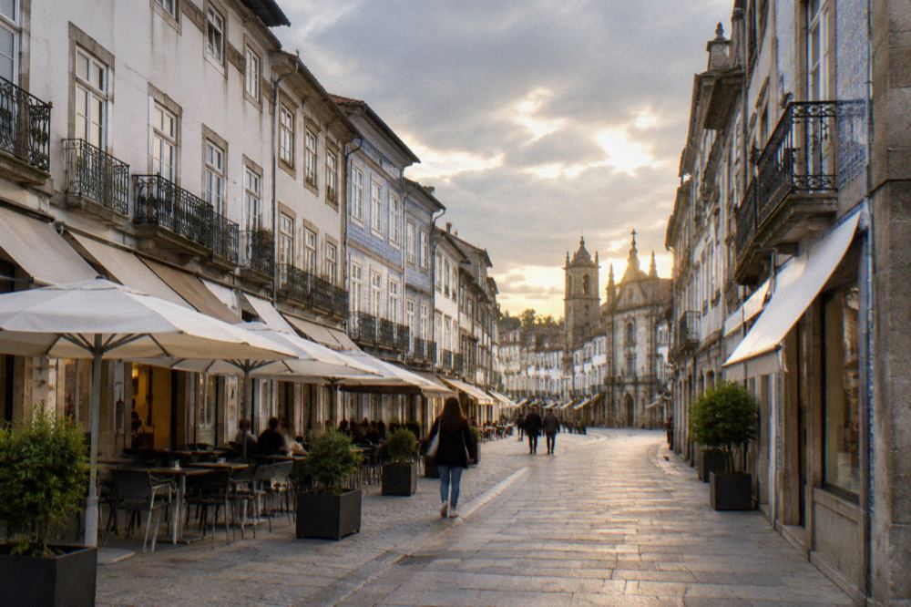 A pedestrian shopping street in Braga with cafe terraces and historic facades