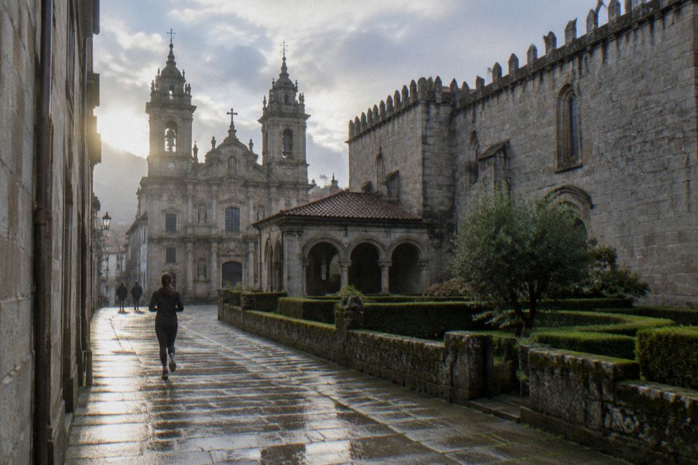 The baroque facade and bell towers of Braga Cathedral seen from a narrow street