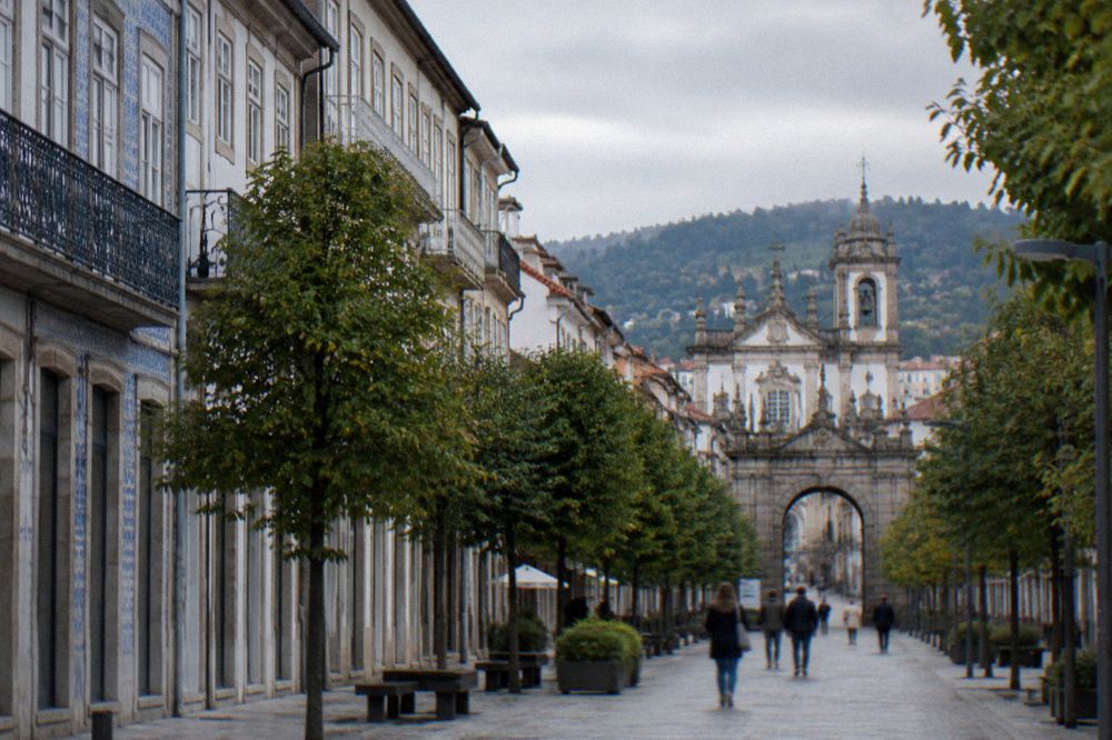 The tree-lined Avenida da Liberdade in Braga leading towards the stone arch at the entrance to the old town