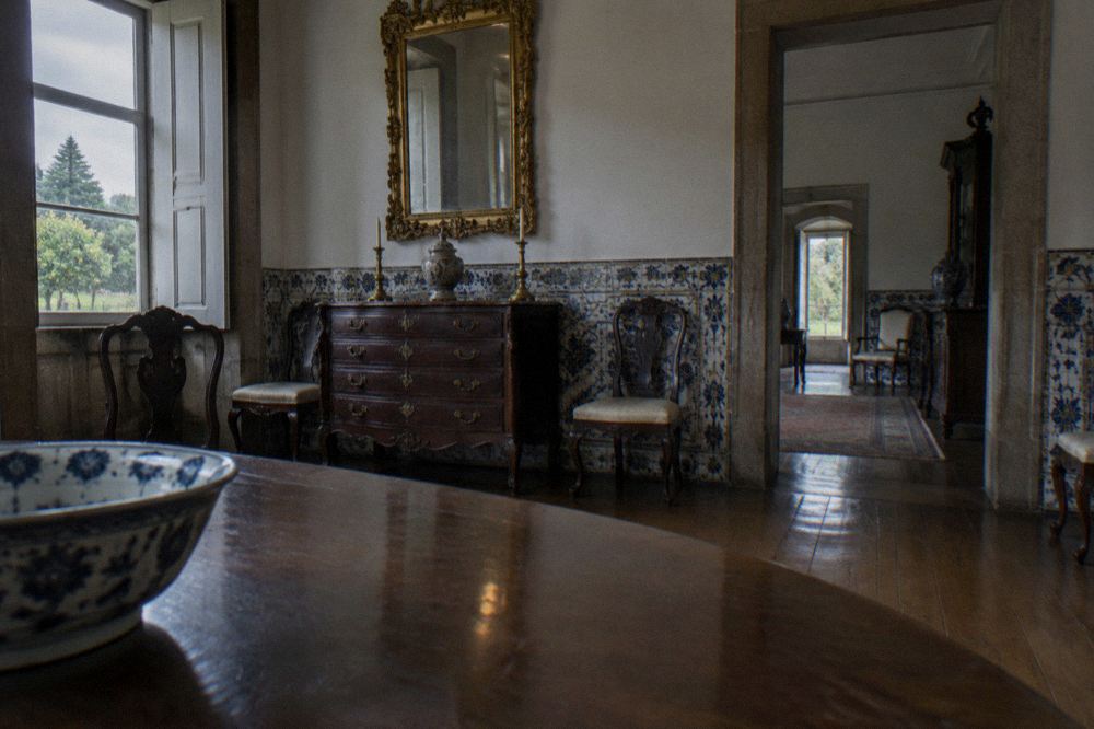 An interior room of the Biscainhos palace museum with antique furniture and patterned tile walls