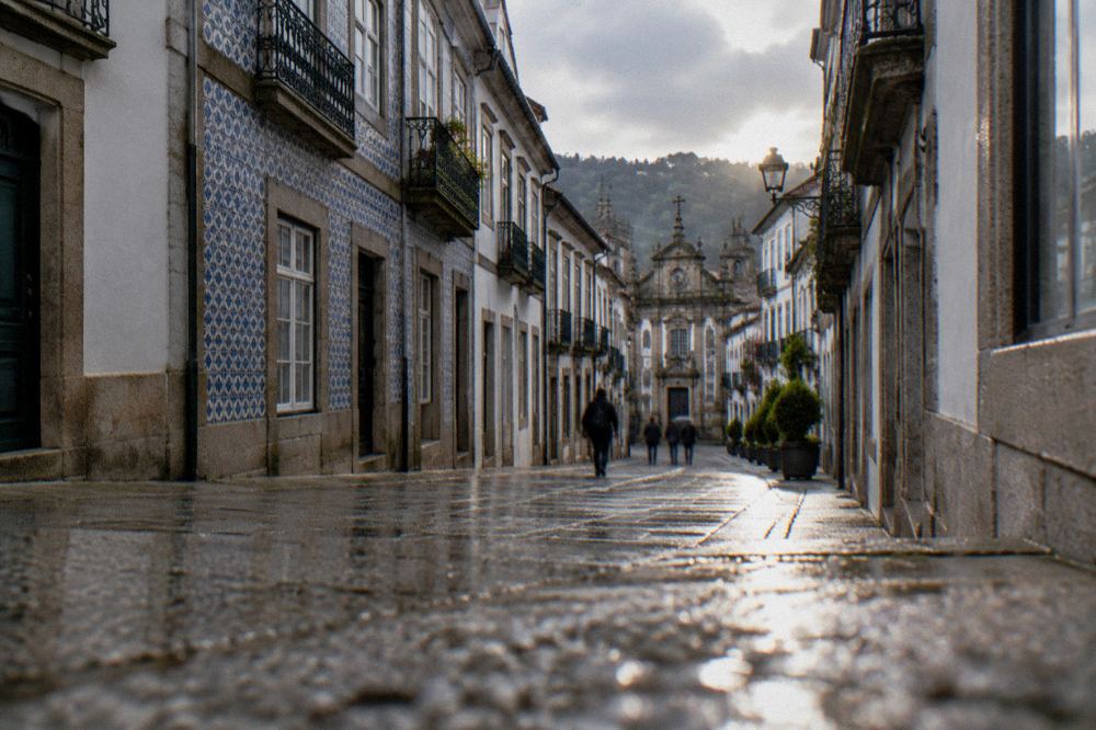 A narrow tiled street in Braga's historic centre leading toward the museum quarter