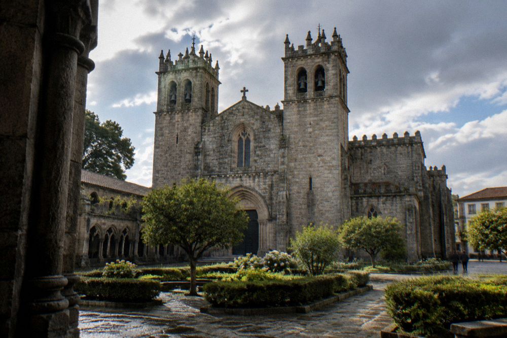 The twin-towered facade of Braga cathedral seen from a garden square nearby