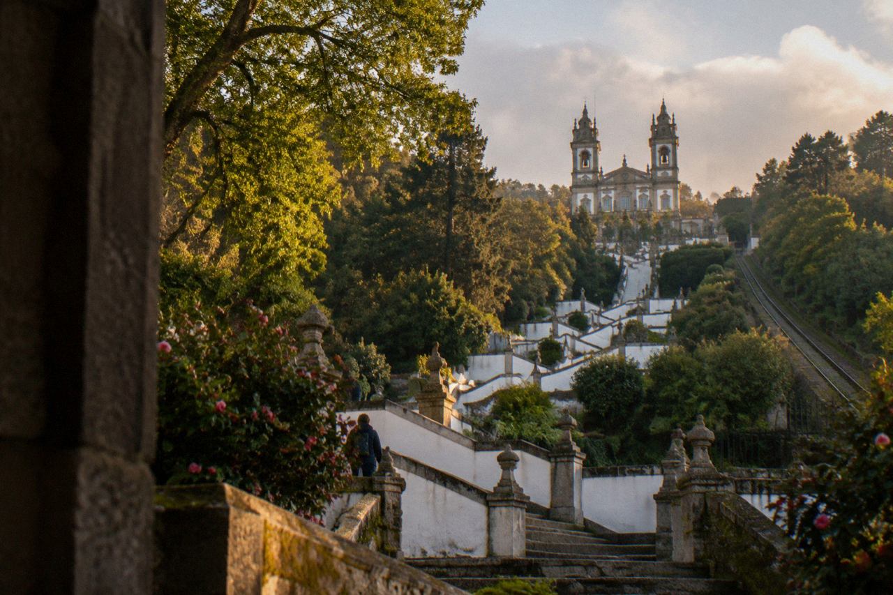 The baroque zigzag stairway of Bom Jesus do Monte rising through trees toward the sanctuary church above Braga