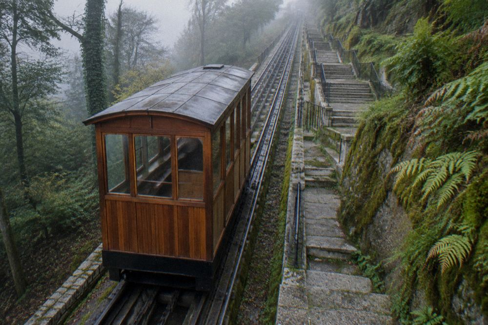 Close view of the wooden funicular car and its rails on the steep incline at Bom Jesus do Monte