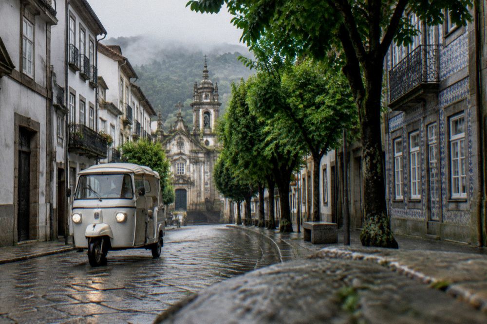 A tuk tuk vehicle on a tree-lined street in the historic centre of Braga