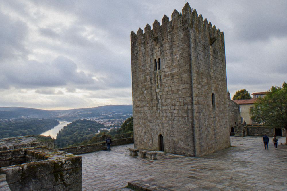 Hilltop castle walls above a green river valley in northern Portugal