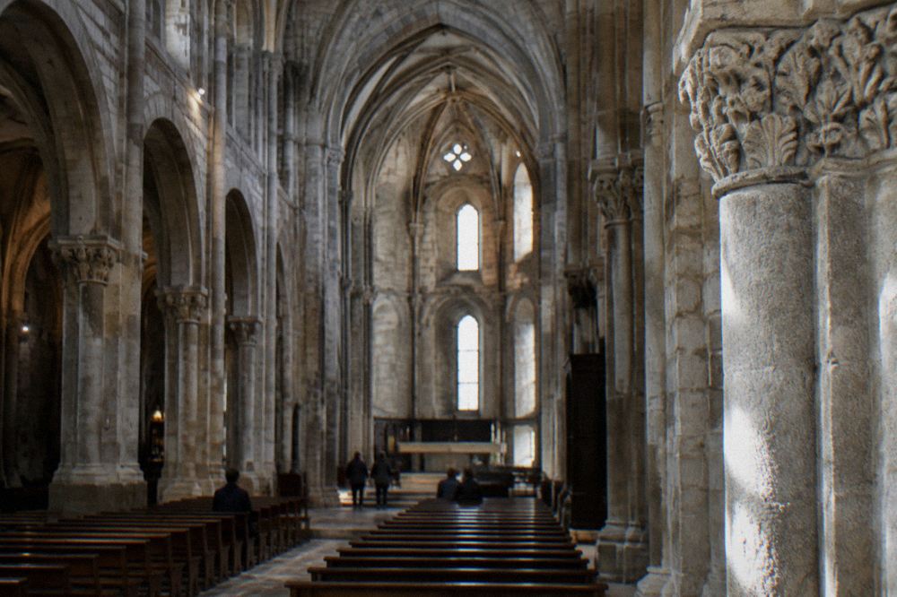 The carved stone interior and vaulted ceiling of Braga Cathedral seen from the nave