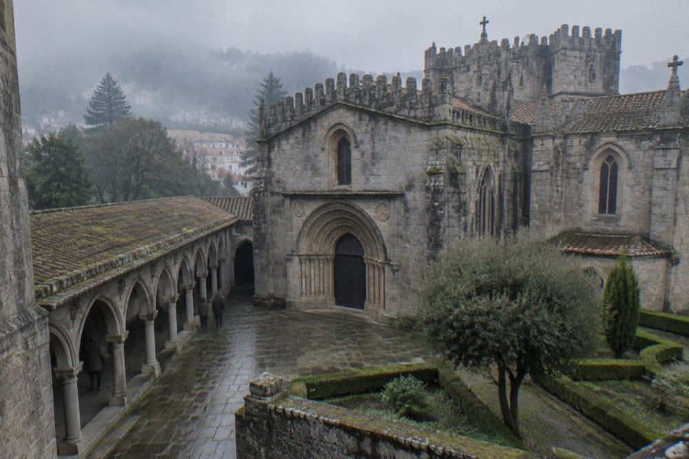 A quiet cloister walkway with stone arches at Braga Cathedral
