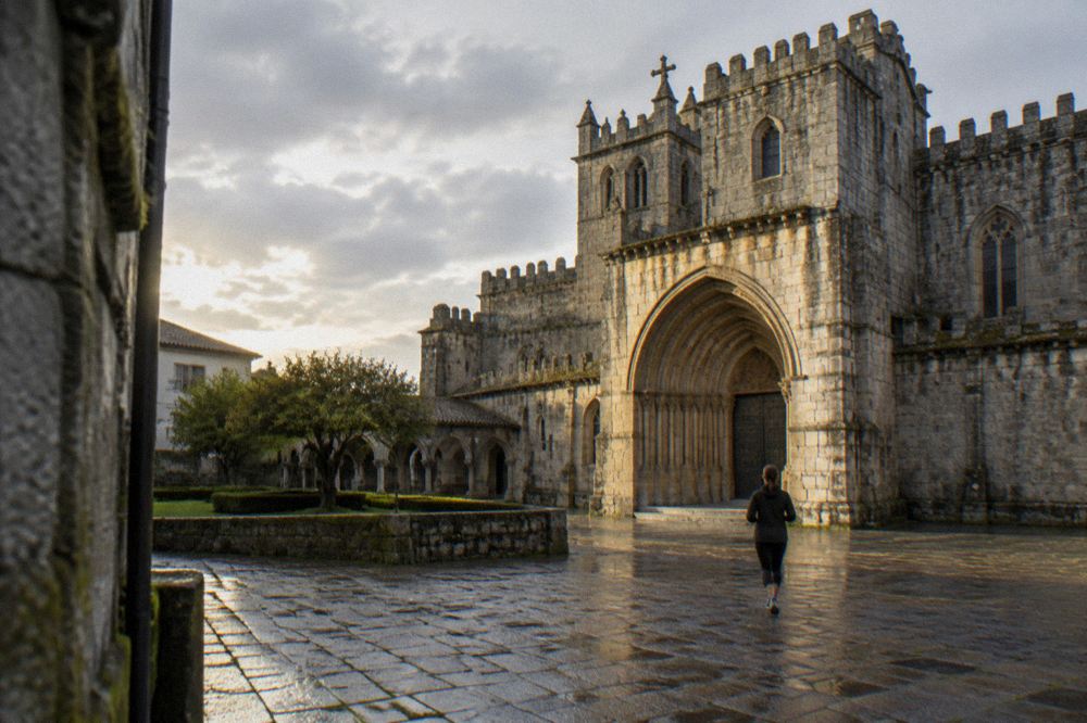 Sunlight falling on the stone facade and doorway of Braga Cathedral in the morning
