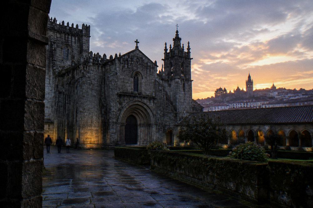 The evening skyline of Braga with the cathedral towers silhouetted against a warm sky