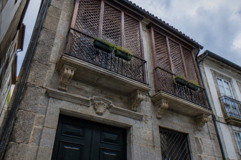 A close view of ornate stone details on the facade of an old Portuguese house