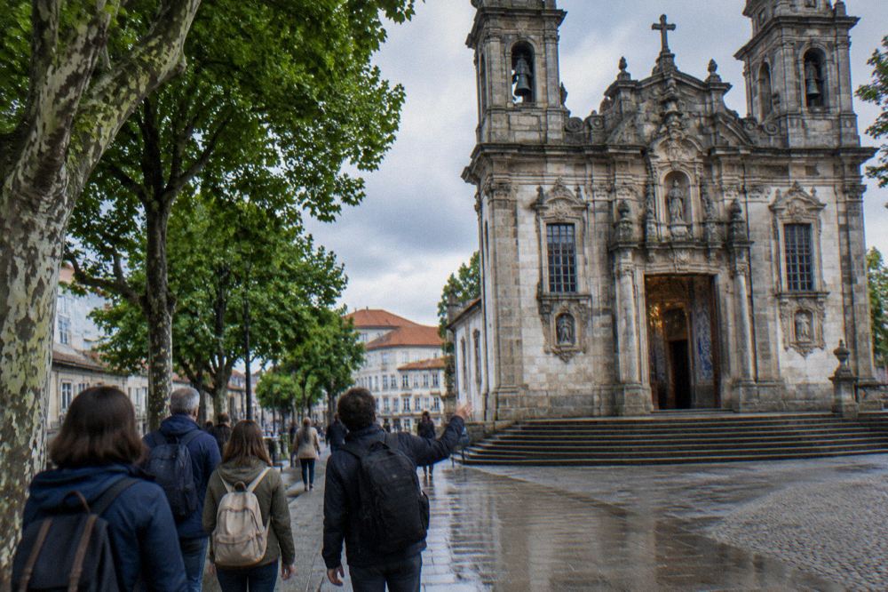 Guide leading a small group of visitors through a historic Portuguese city street