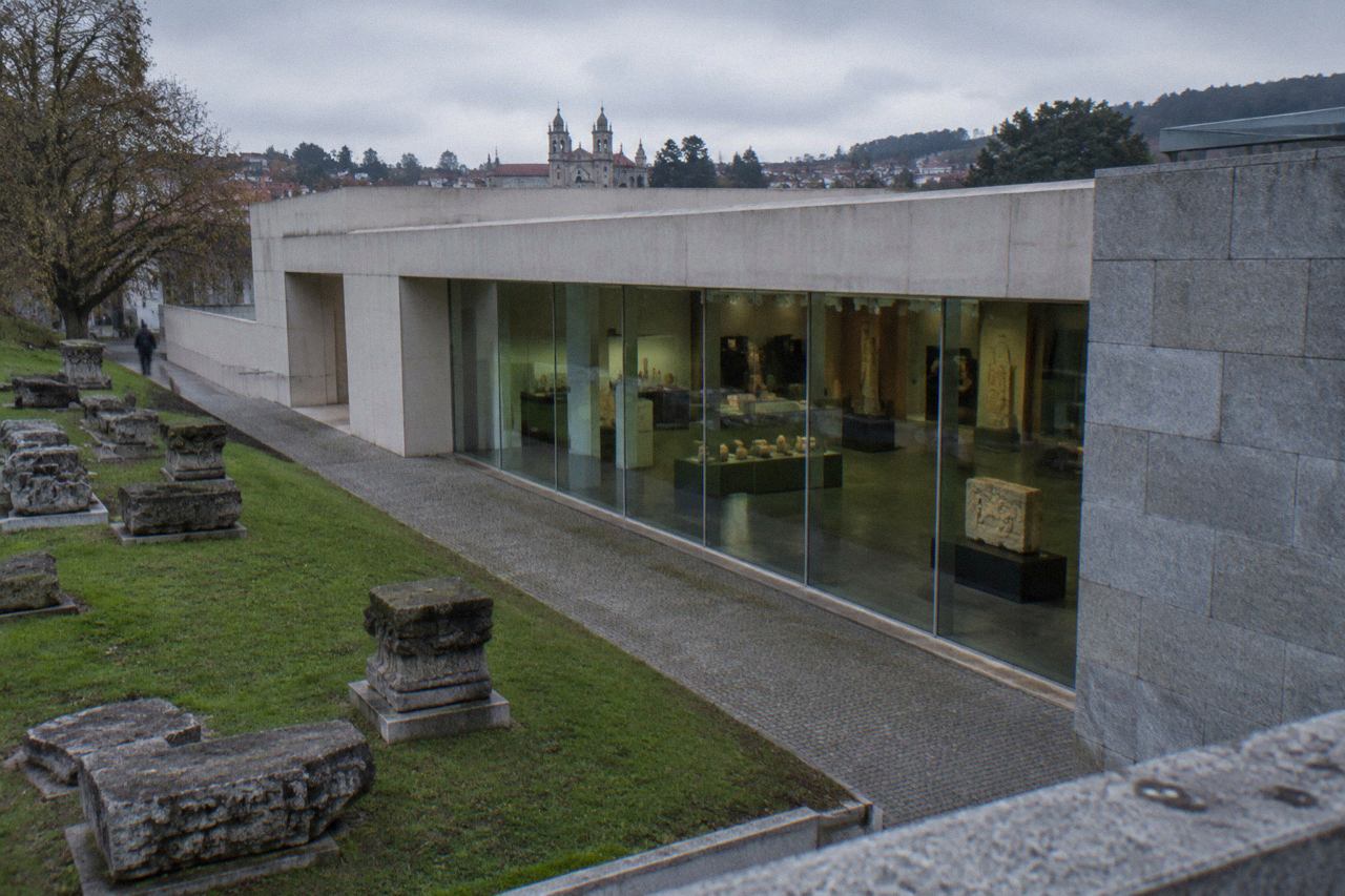 Stone carvings and display cases inside an archaeology museum gallery