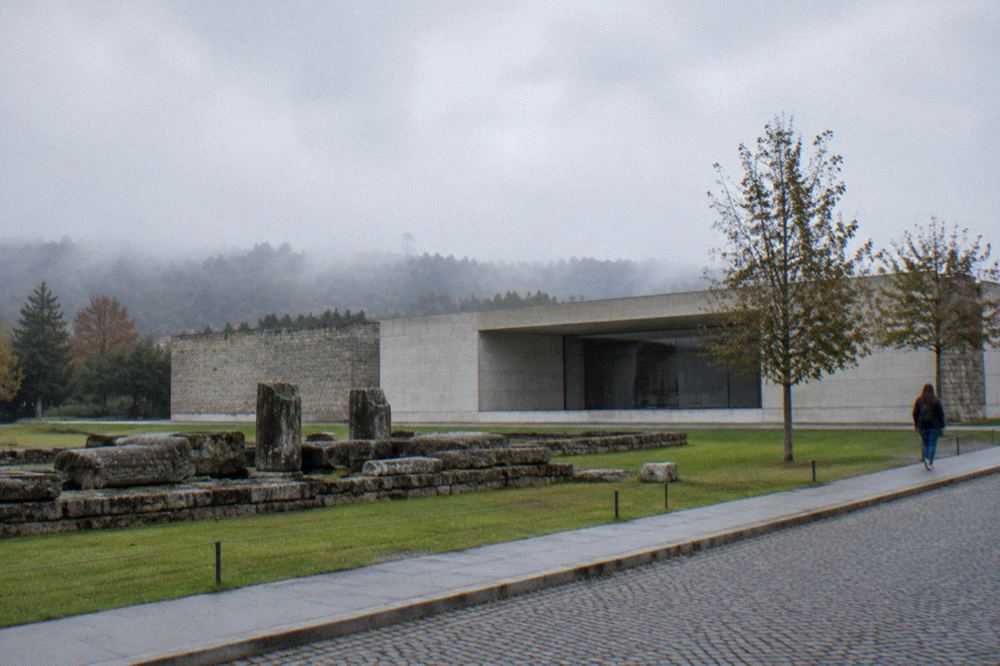 Latin stone inscription mounted on a museum wall beside explanatory text