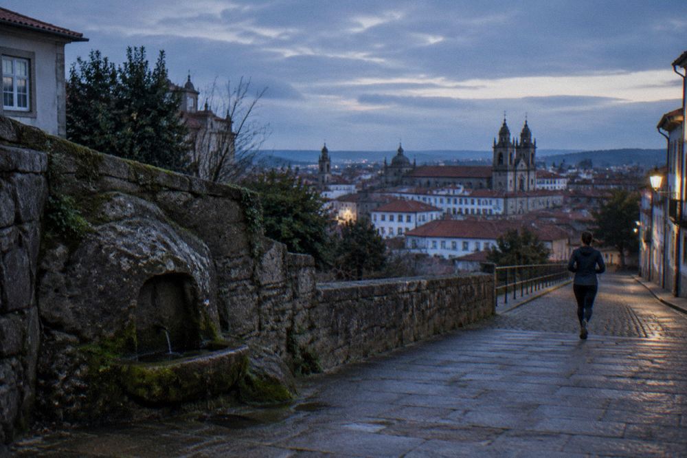 A wide view of Braga's historic rooftops with church towers rising above the city