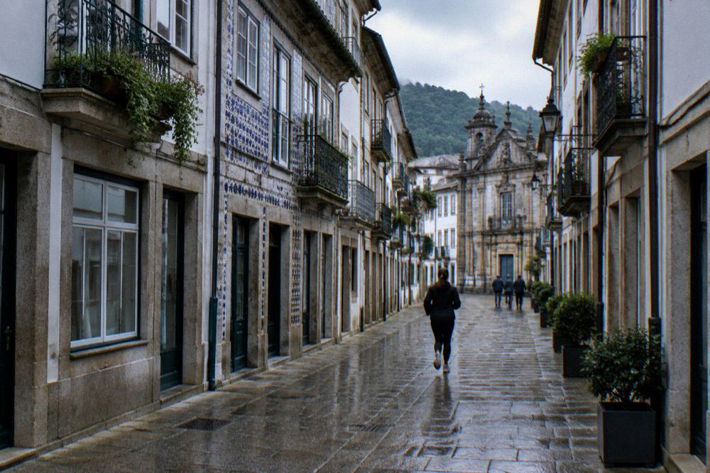 A quiet cobbled street in Braga with granite buildings and soft morning light