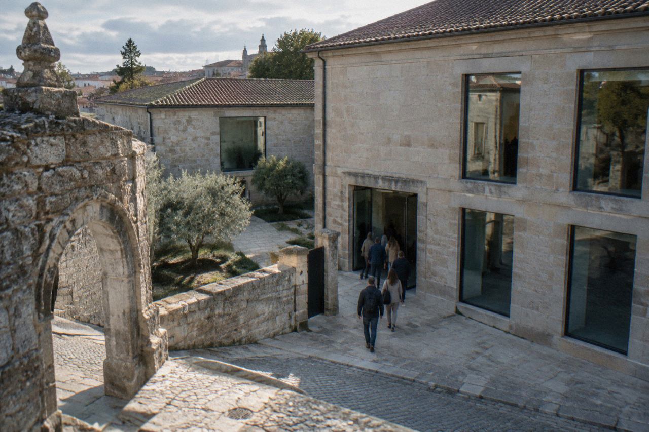 A historic stone building housing a photography museum in Braga, with an entrance courtyard and visitors at the door