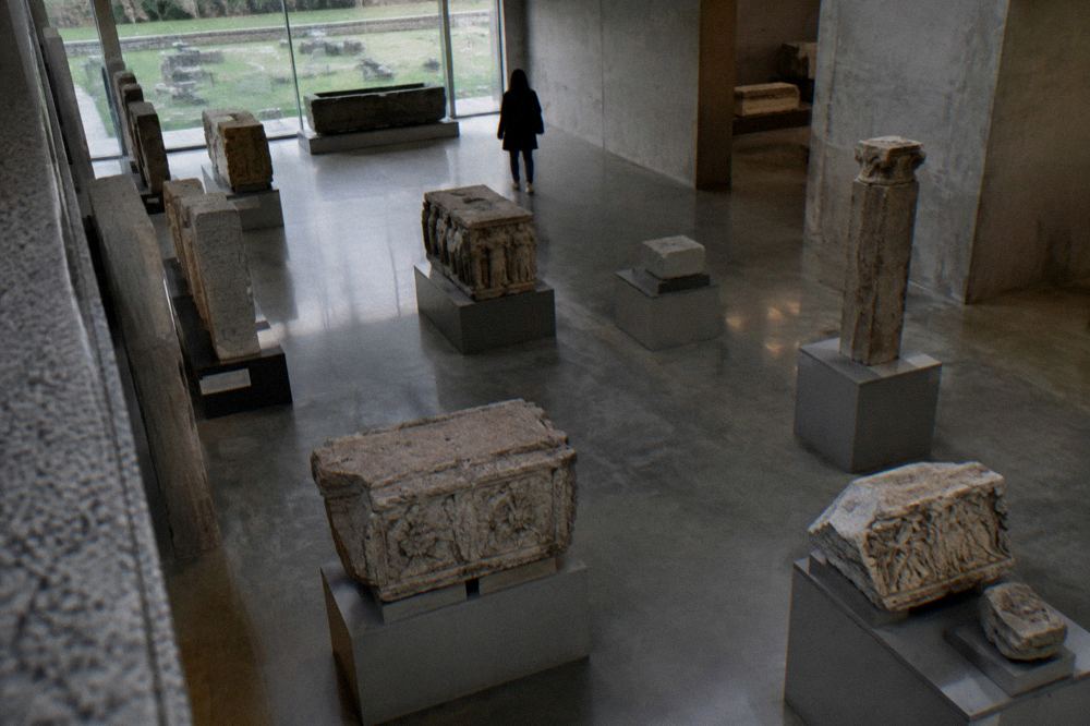 An archaeology museum gallery with Roman stone carvings displayed on plinths