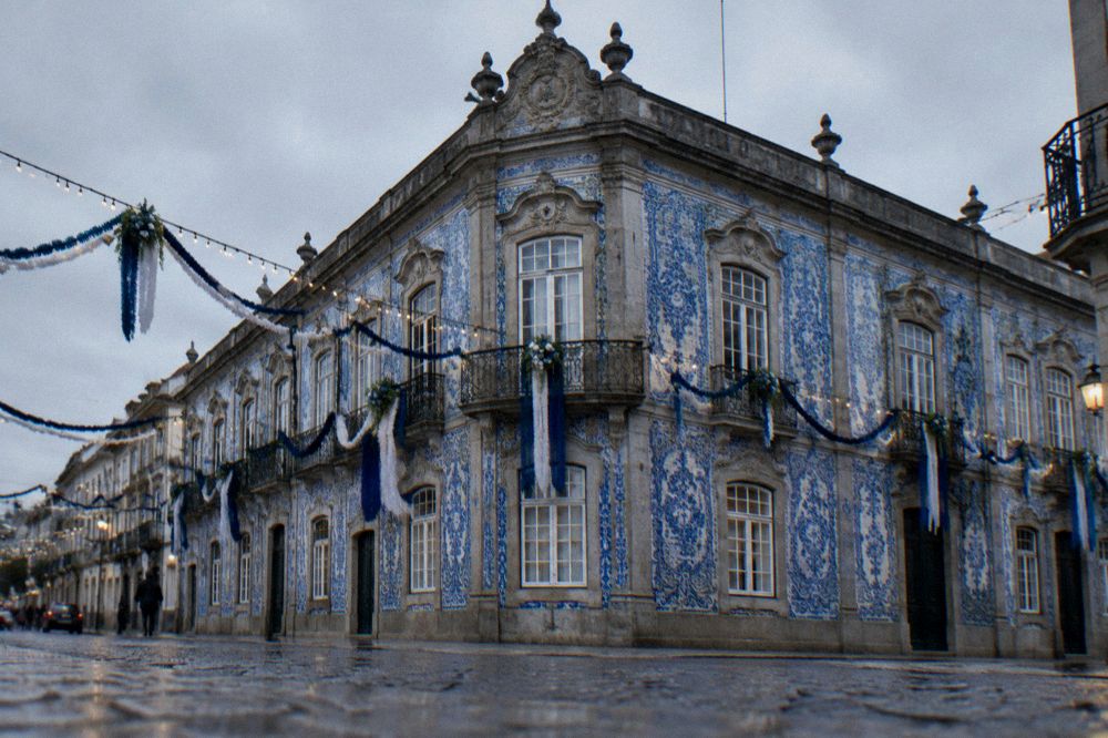Baroque building facade decorated with flags and lights for a city festival