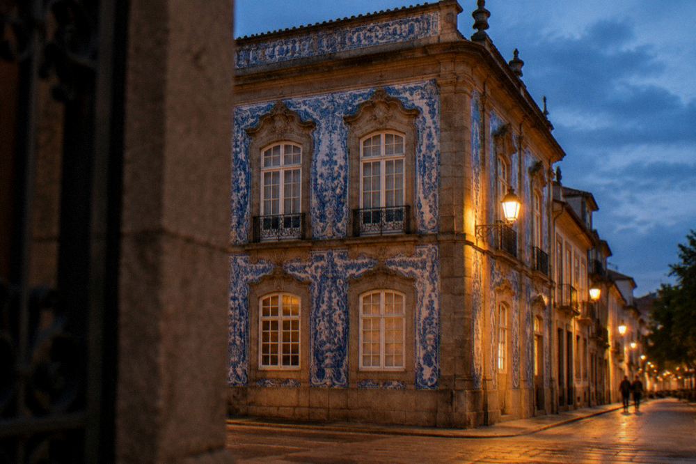 Golden evening light on an ornate palace facade in a Portuguese city street