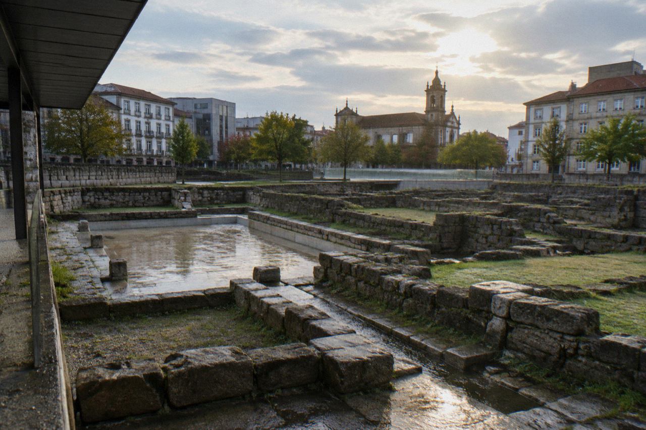 Ancient stone remains of Roman baths set into a modern urban square in Braga