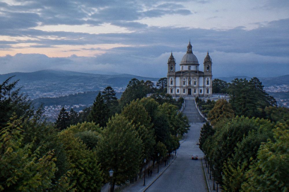 A wide view of the Sameiro basilica towers from the tree-lined approach road