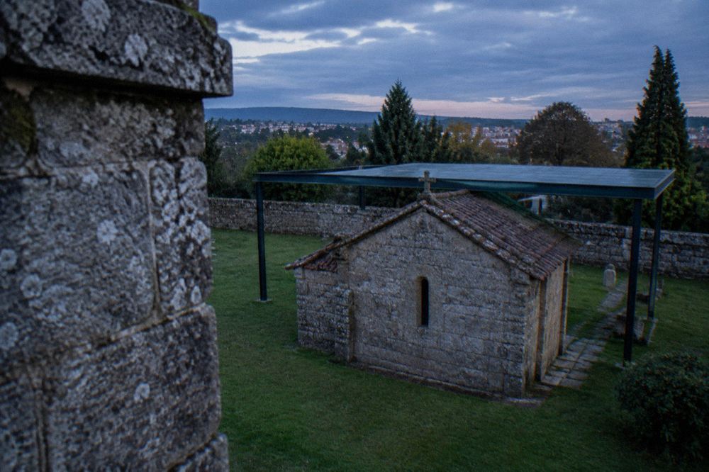 A close view of weathered granite stonework on an early medieval chapel wall
