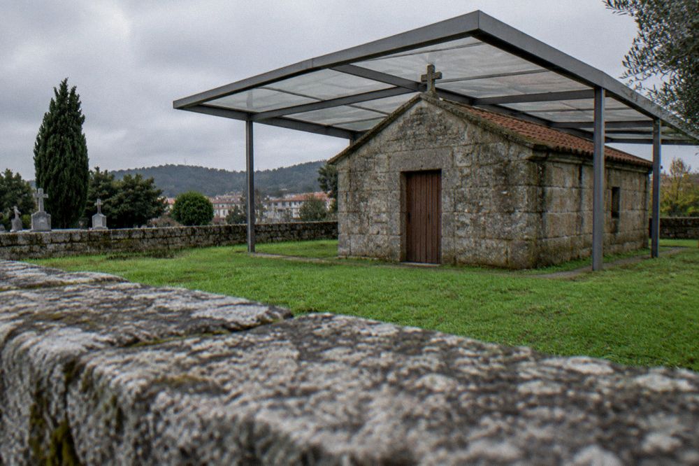 A simple wooden door set into an old stone chapel facade
