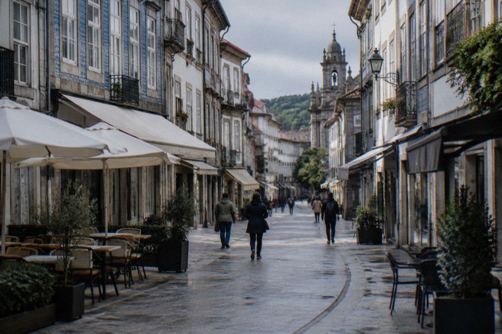 A pedestrian shopping street in Braga with cafe tables and historic buildings