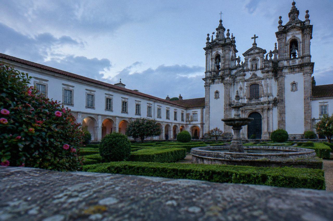 The ornate facade of the Monastery of São Martinho de Tibães under a clear sky