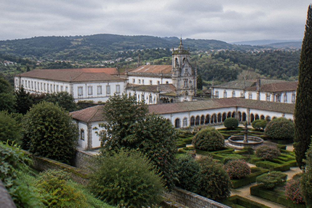 Wide view of the monastery buildings and green hillside around Tibães near Braga