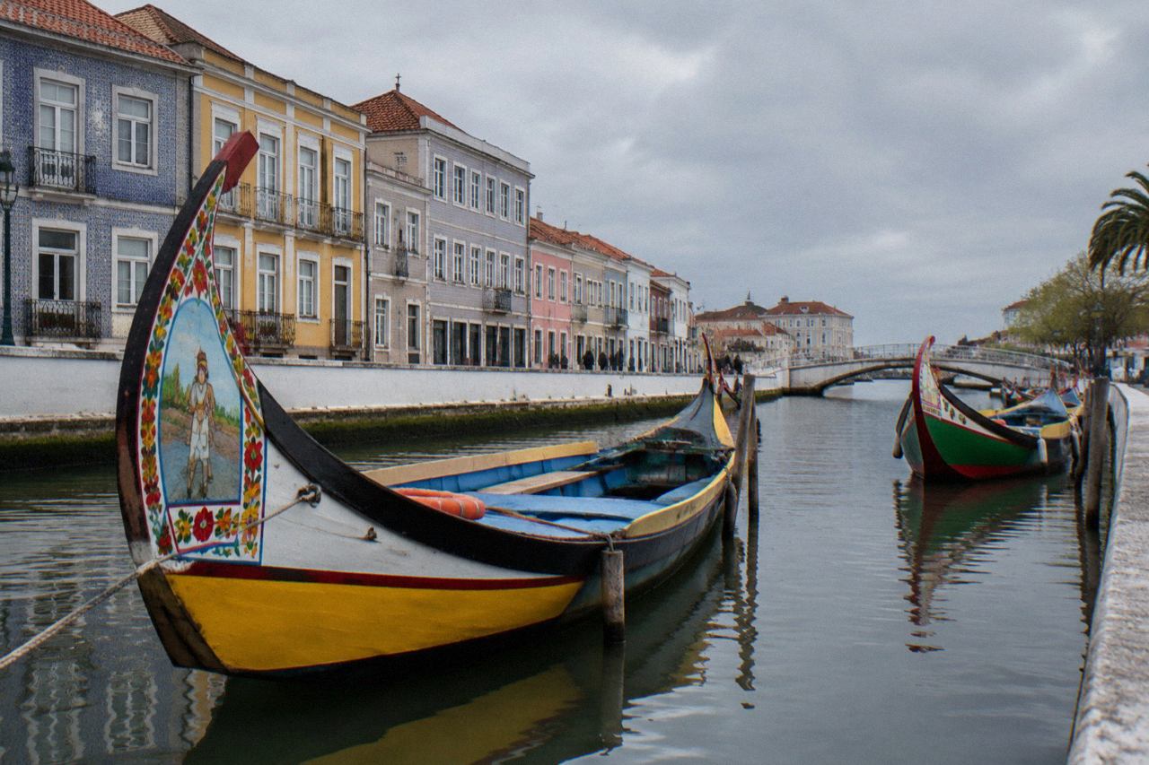 Colourful moliceiro boats moored along one of Aveiro's city canals