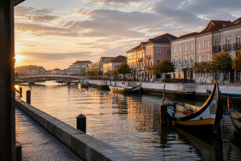 Wide view over Aveiro's central canal with boats and pastel buildings at golden hour