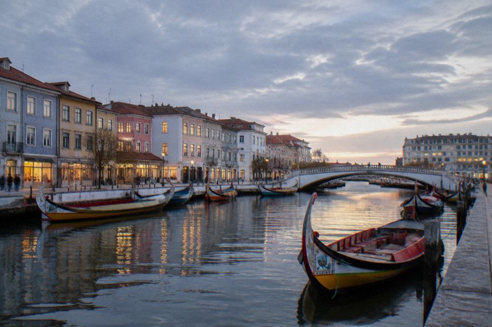 Aveiro canal in soft evening light with a bridge and moored boats